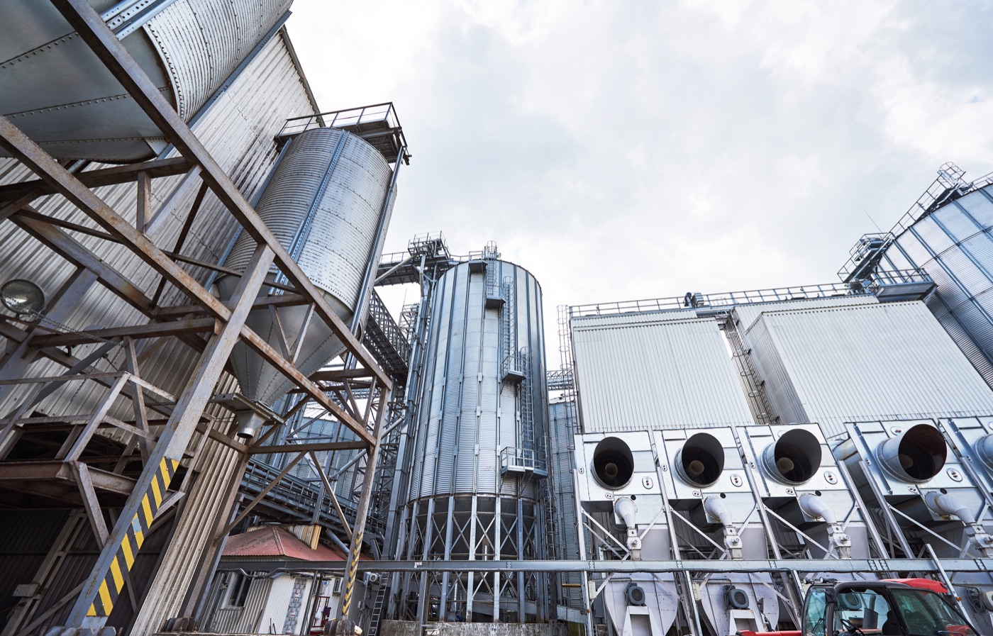 Industrial plant and storage infrastructure for biomass delivery