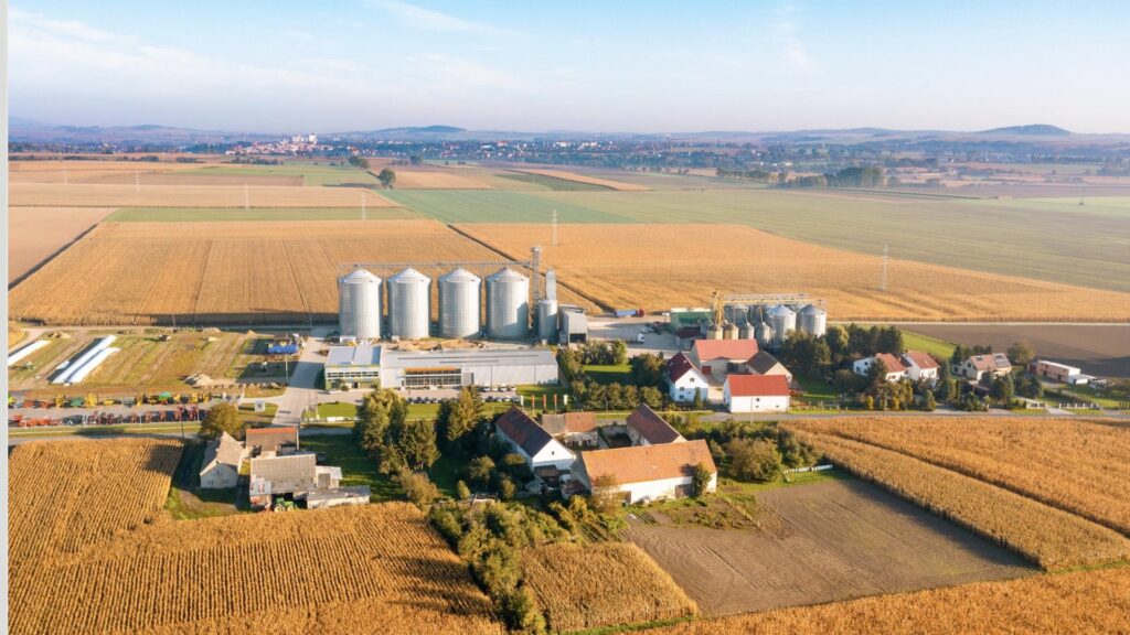 Aerial view of a regional feedstock basin connecting farmland, storage, logistics and biomass-processing infrastructure.