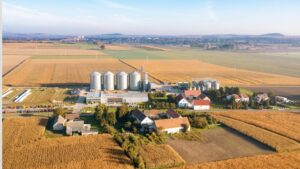 Aerial view of a regional feedstock basin connecting farmland, storage, logistics and biomass-processing infrastructure.