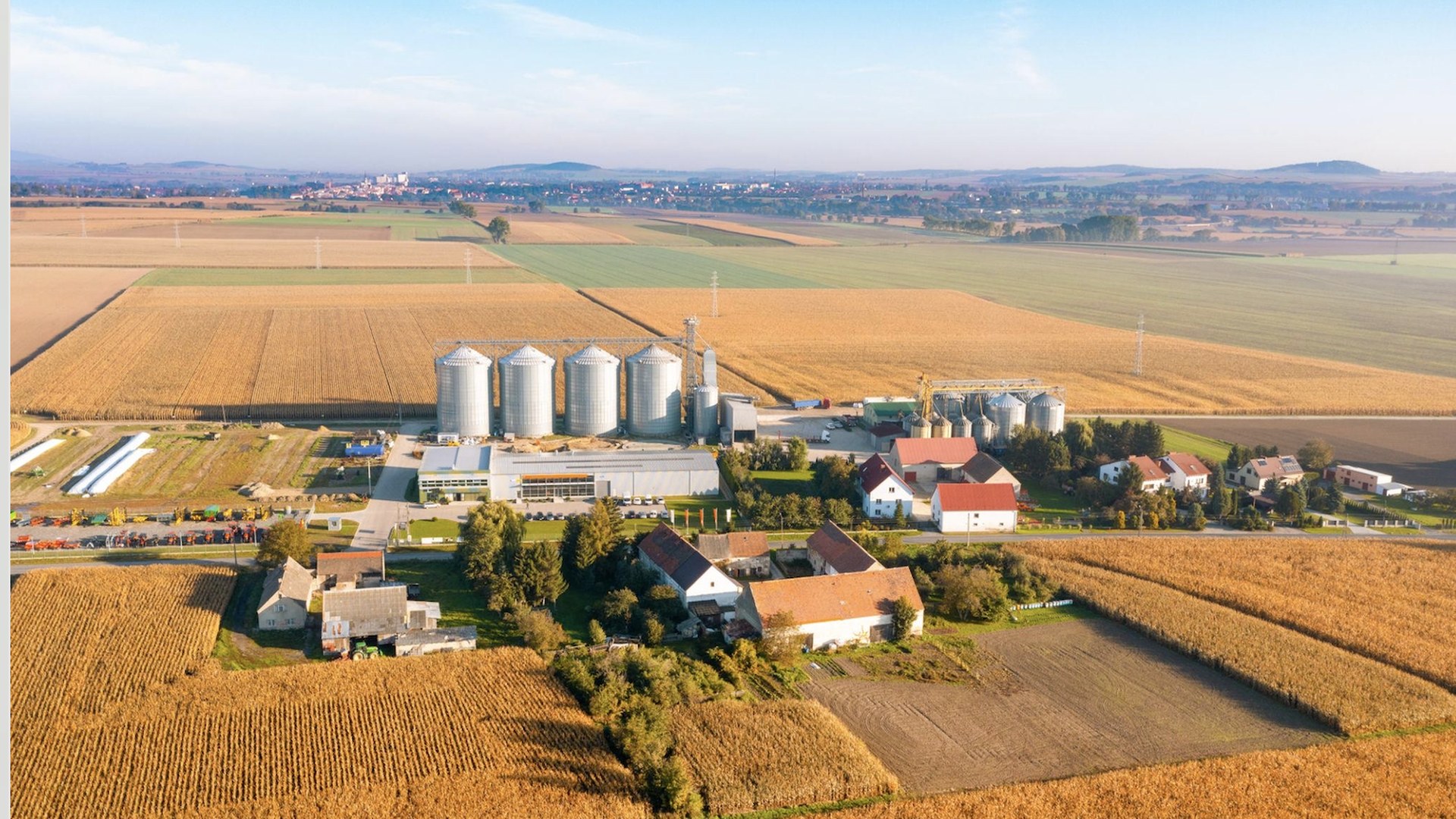 Aerial view of a regional feedstock basin connecting farmland, storage, logistics and biomass-processing infrastructure.
