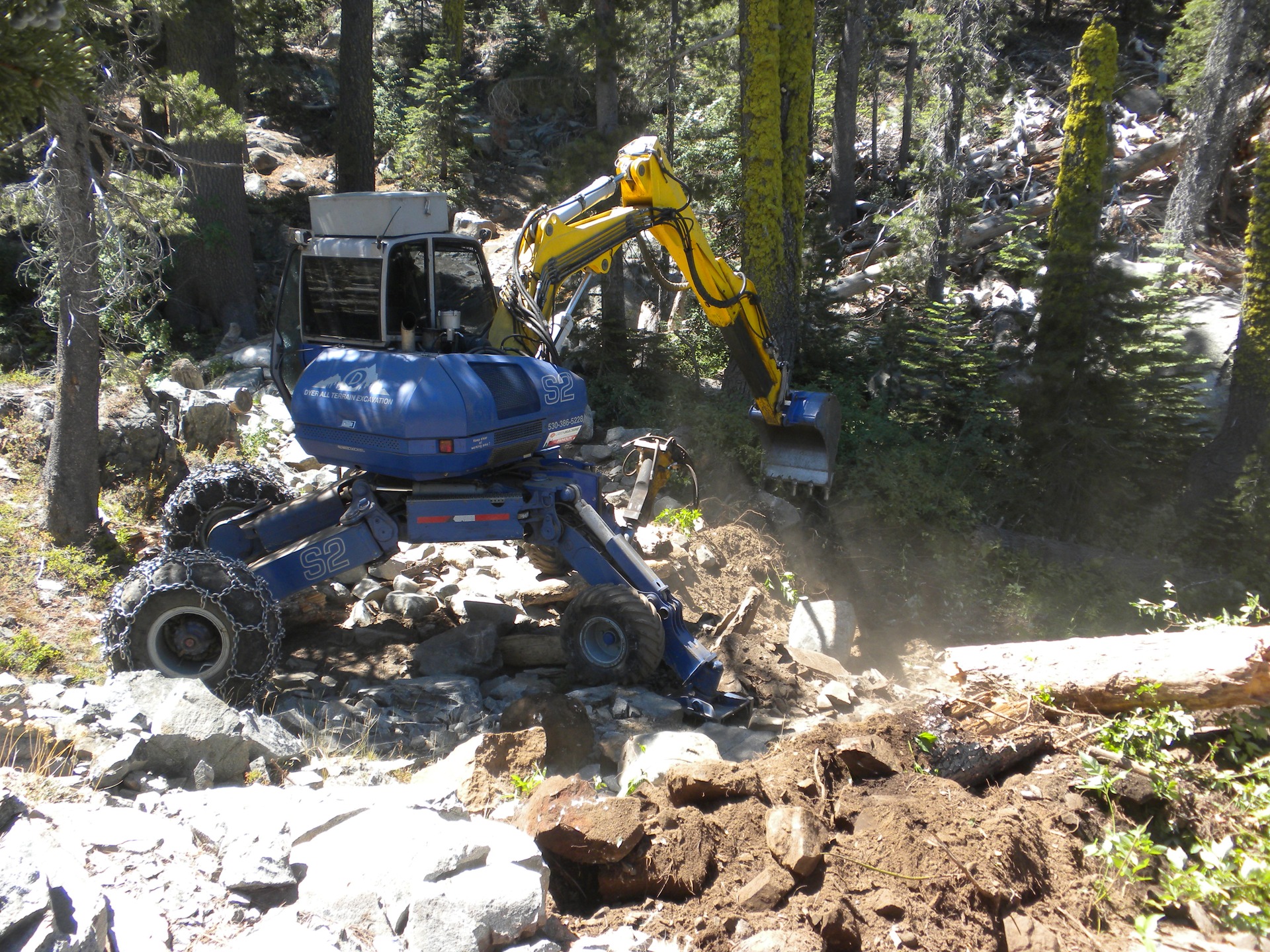 Forest restoration work in Tahoe National Forest, California, United States, July 2014. Terrain and access shape the cost of recovering woody material. Historical regional restoration photograph; the Cabin Creek plant is not depicted.