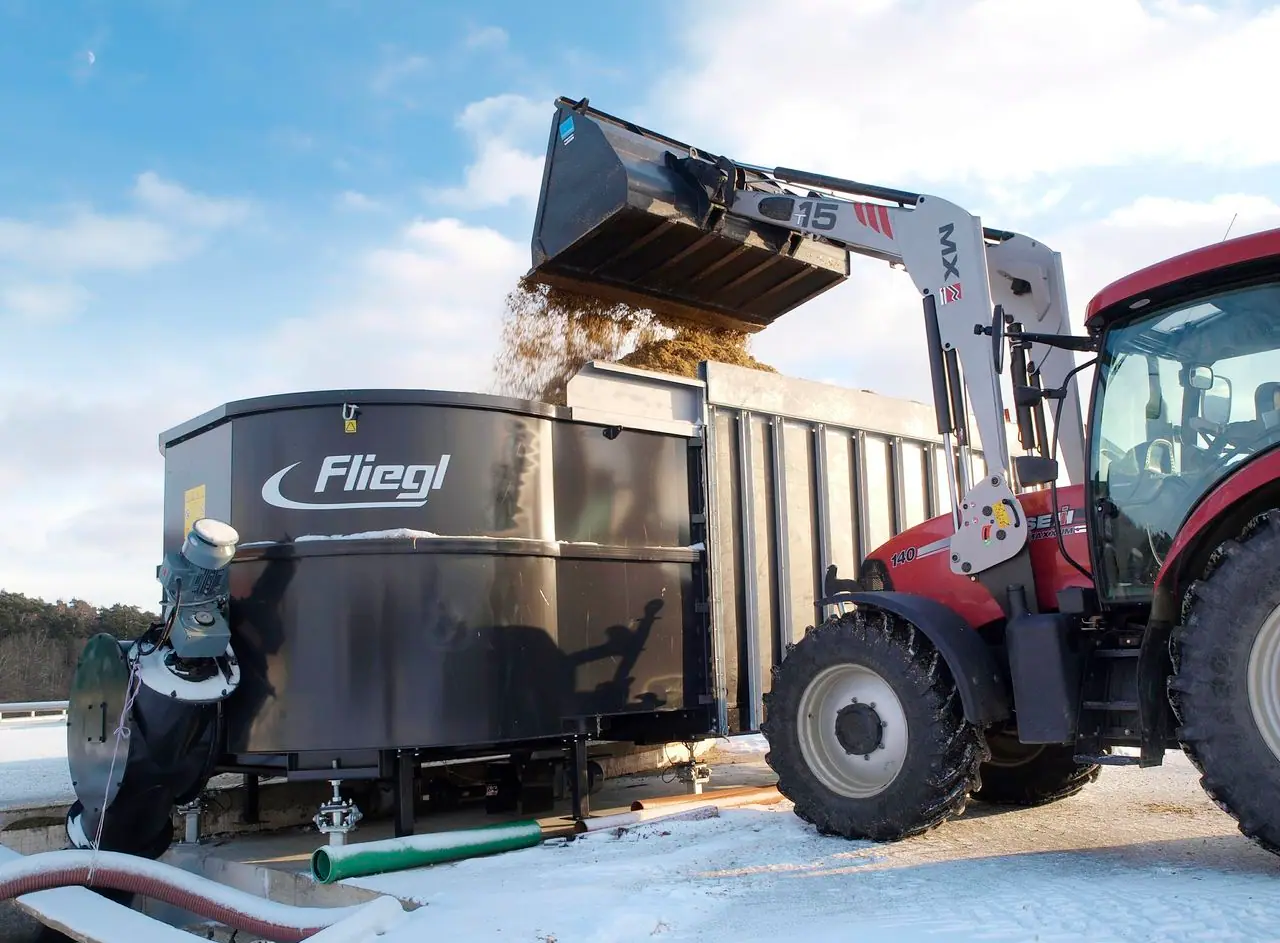 Industrial biomass receiving and mixing equipment feeding an anaerobic-digestion system