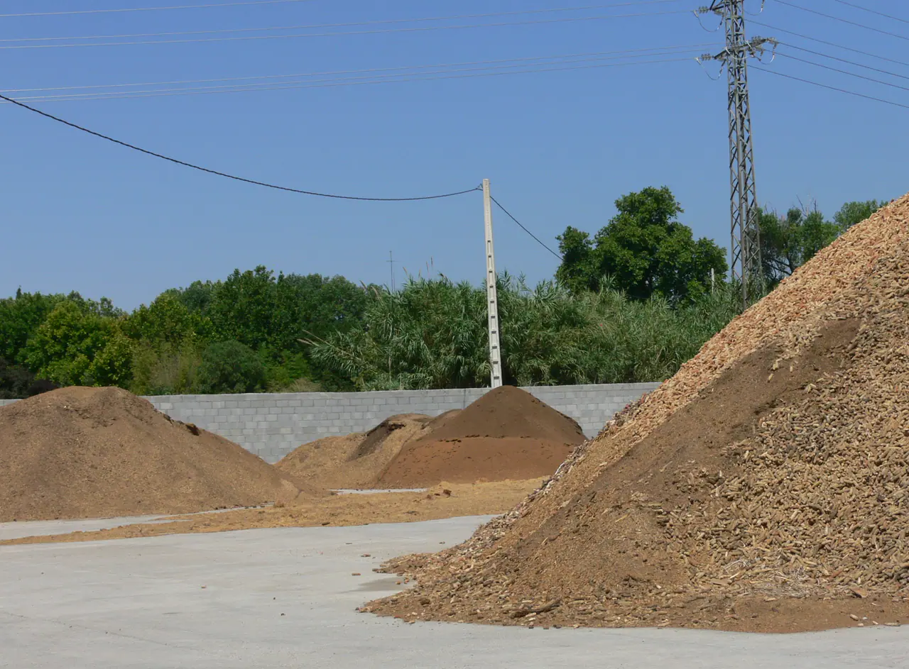 Separated biomass stockpiles in an aggregation and seasonal storage yard
